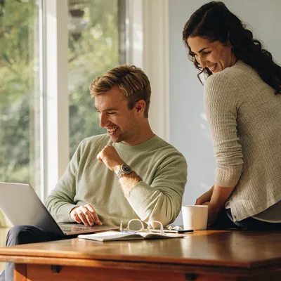 young man and woman looking on a computer